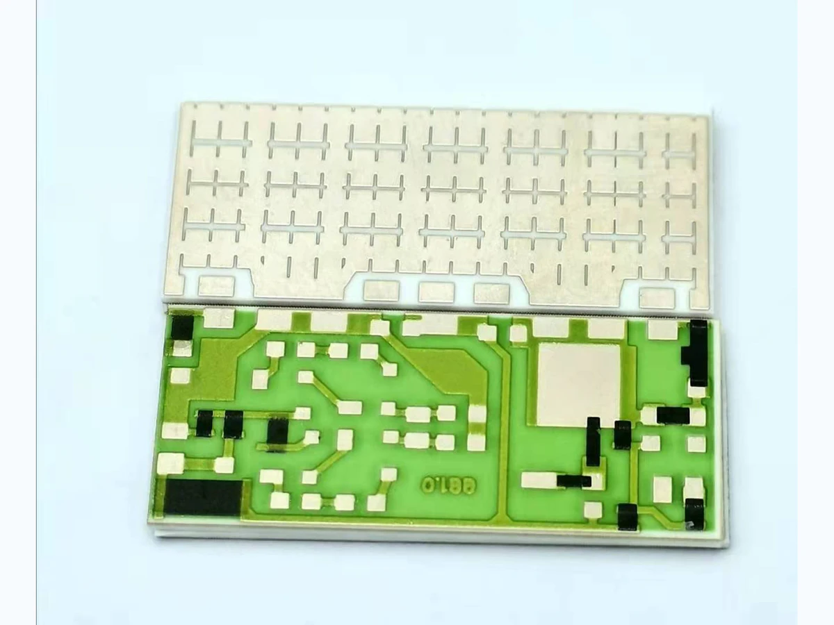 Real printed thick film resistor samples showing rectangular resistor bodies between conductor terminations
