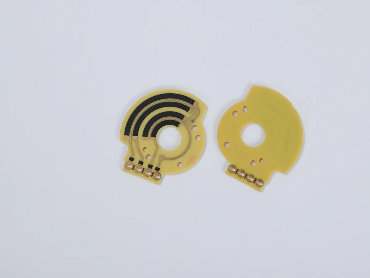 Controlled detail crop of a verified rotary carbon film sensor PCB showing concentric tracks and terminals