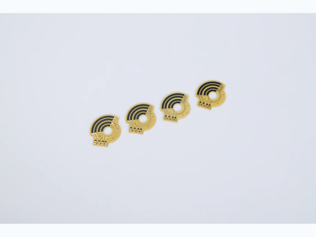 Four small rotary carbon film sensor PCBs with concentric black tracks and center openings