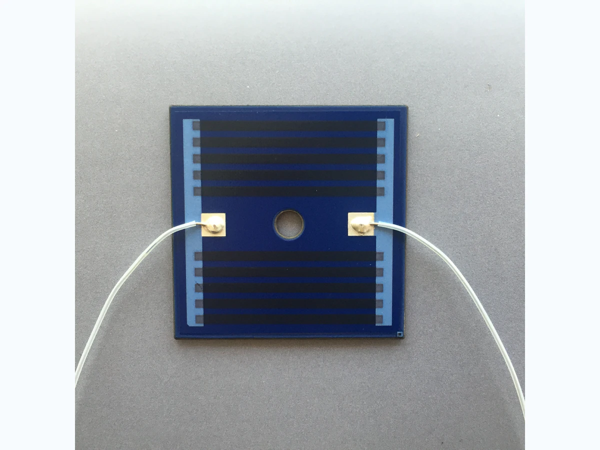 Real stainless steel thick film heater showing printed electrical layers on an insulated metal substrate