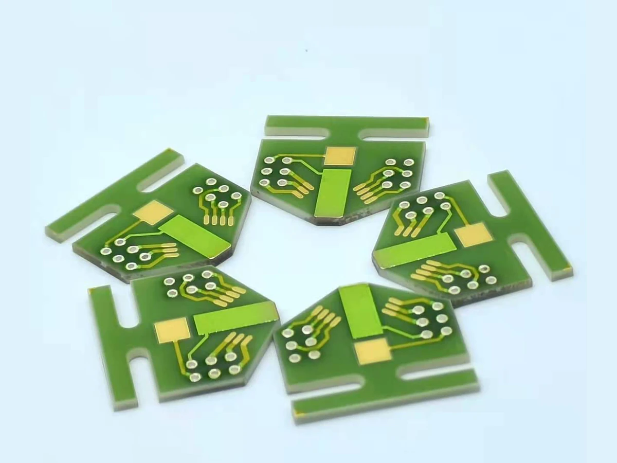 Group view of ceramic thick film circuit forms with repeated ringed apertures and printed routing