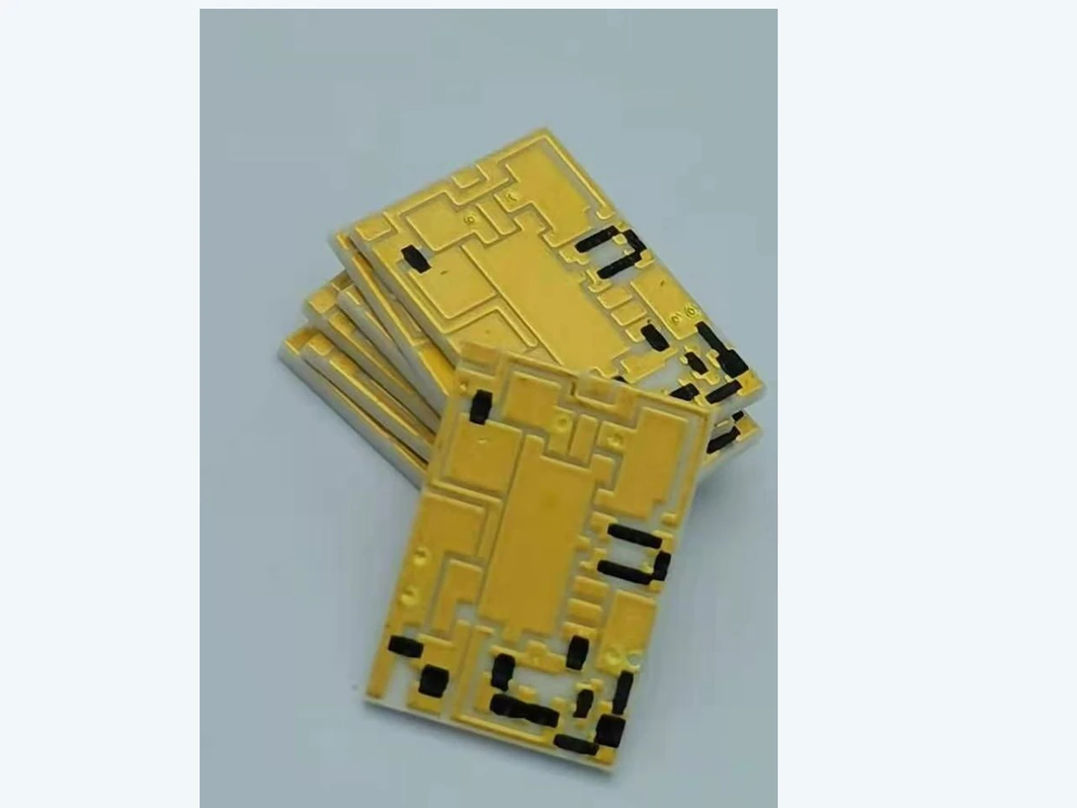 Verified angled view of stacked thick film filter circuits showing repeated artwork and ceramic edges