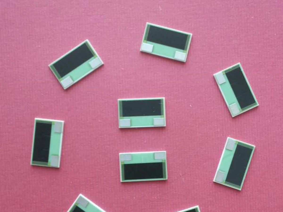 Controlled detail crop of a verified thick film power resistor showing the broad printed film and end terminals
