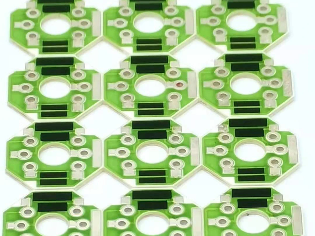 Controlled detail crop of a verified thick film voltage divider showing paired resistor films, conductor paths, and terminals